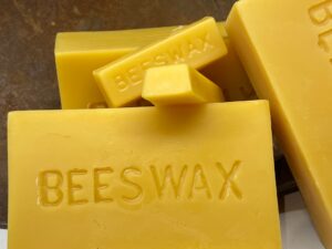 Blocks of natural yellow beeswax with embossed labels.